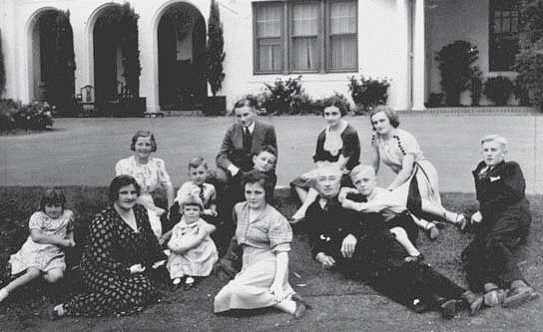Prime Minister Lyons, Dame Enid Lyons and their family on the lawn at the Lodge, Canberra NLA